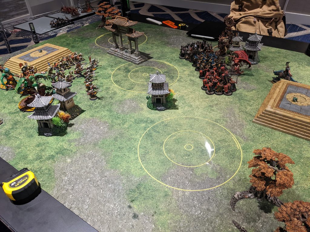 Two Age of Sigmar armies face off after deployment on terrain filled table