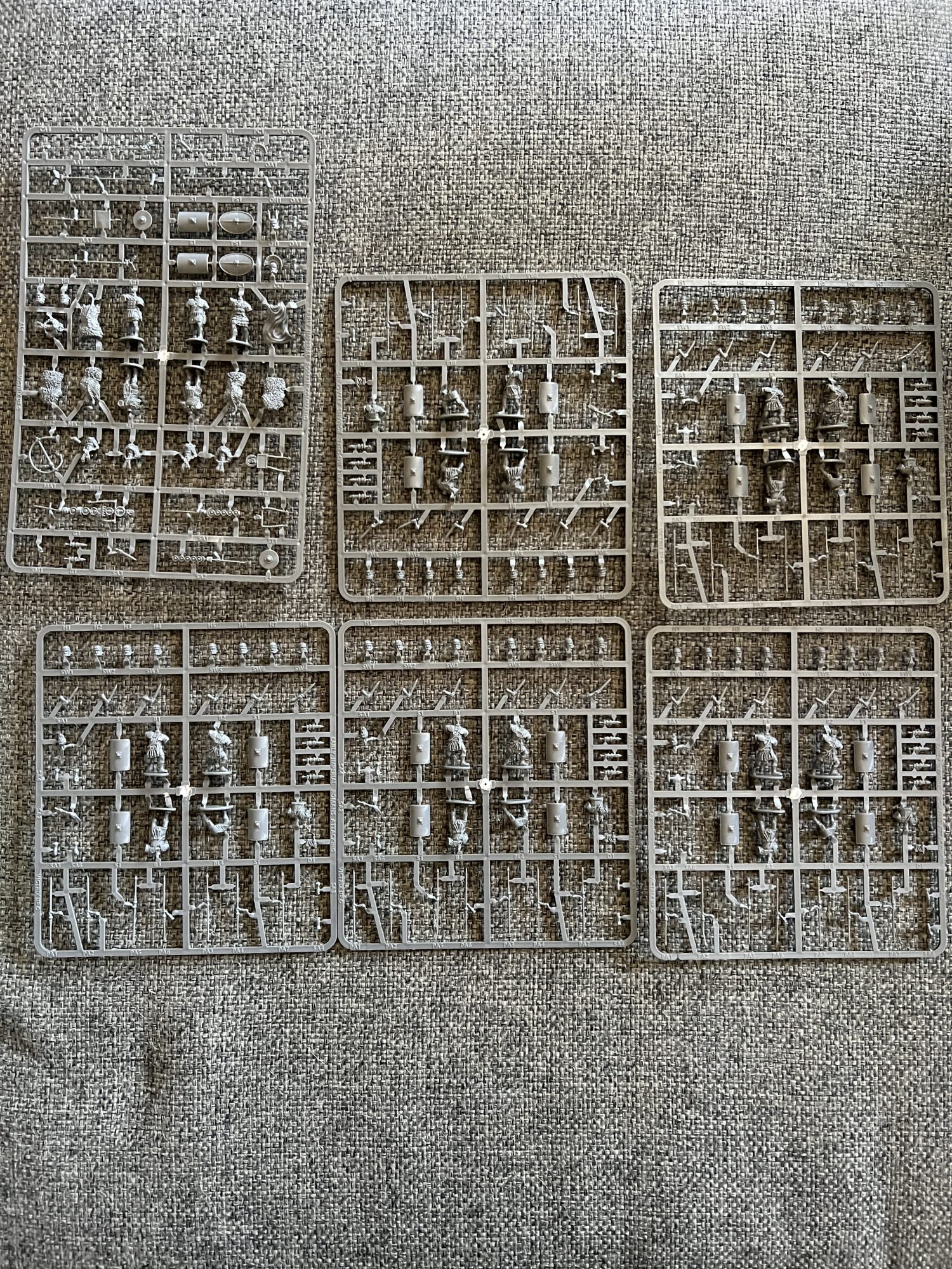 A collection of sprues containing miniatures of Roman Legionnaires.
