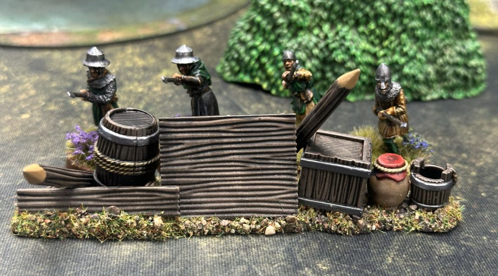 Four spearmen behind a barricade